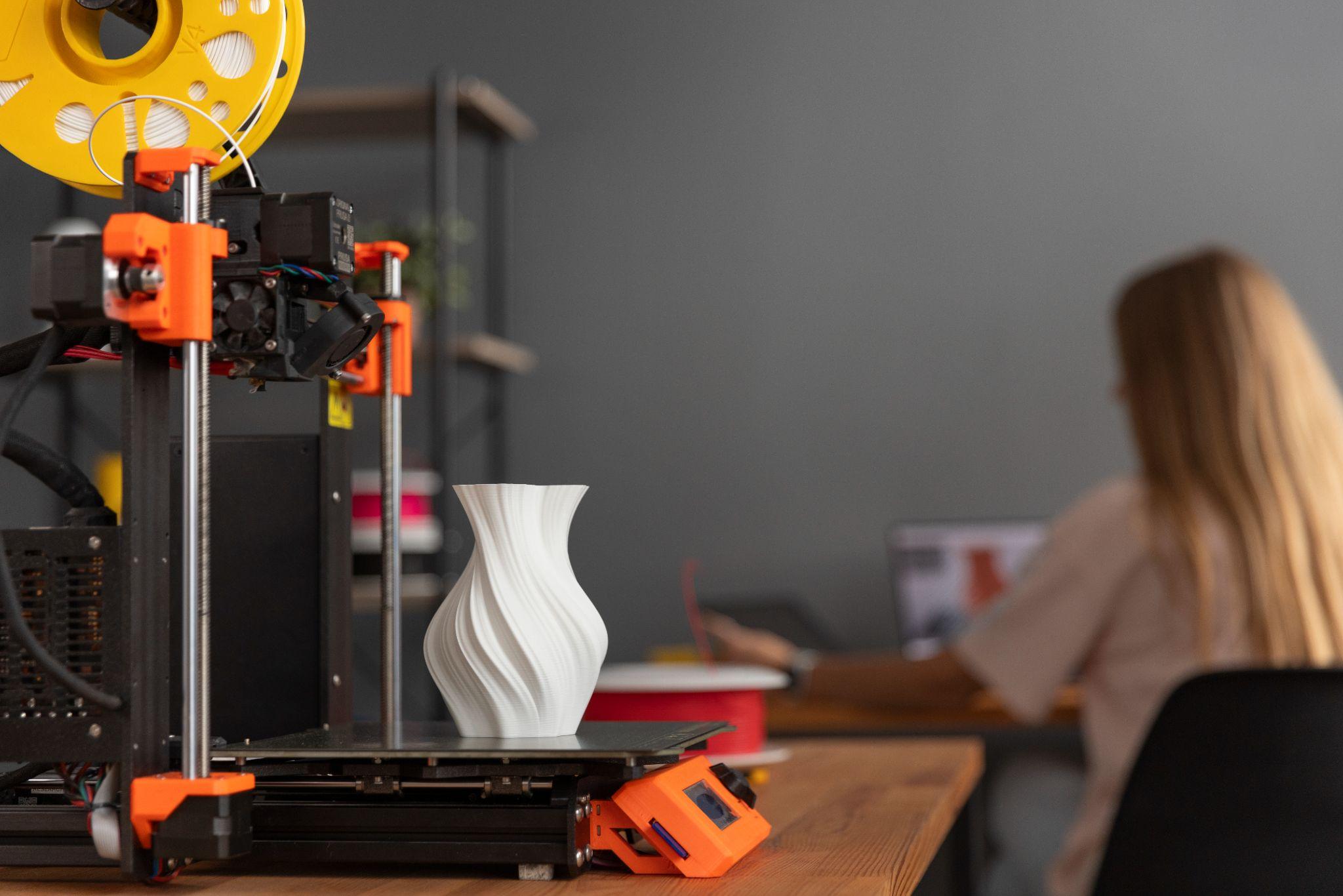A white vase 3d printed design from a machine